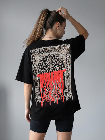 Person wearing a black t-shirt with a "MONARCH" design on the back against a gray background