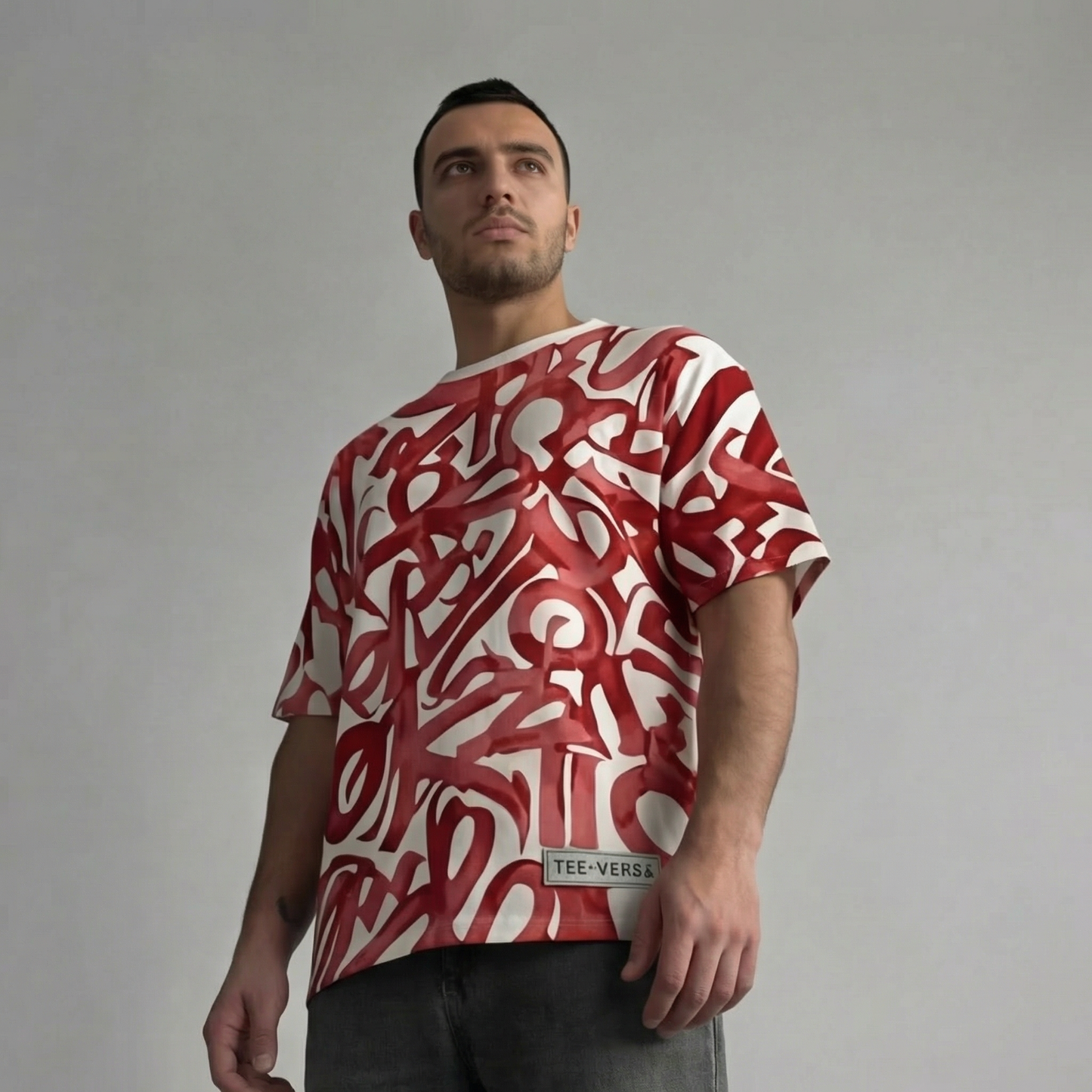 Man wearing a red and white patterned t-shirt against a gray background