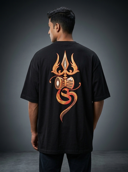 A man viewed from the back wearing a black t-shirt with a large metallic copper-orange graphic on the back, set against a dark gray studio background.